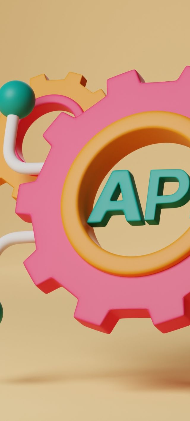 Färgglada kugghjul med texten API, symboliserar webbutveckling och integration av AI-teknologi i appdesign